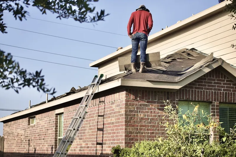 Professional roofer working on a residential roof in Pennfield